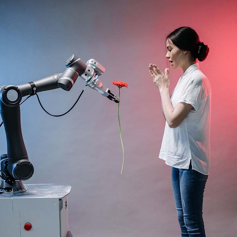 ai-optimering_och_geo_ for_hemsidor_och_e-handel Robot ger flicka en blomma. Ai-optimering och geo for hemsidor och e-handel.